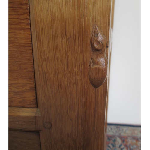 1364 - Robert Mouseman Thompson of Kilburn - an oak panelled kneehole desk or dressing table, adzed top abo... 