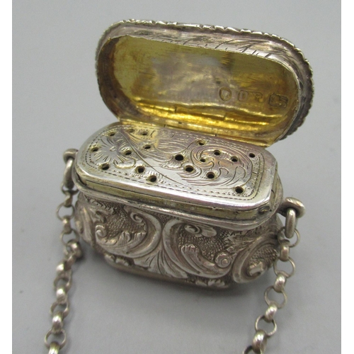 1047 - Victorian silver vinaigrette in the form of a handbag on a chain with finger ring handle, chased and... 