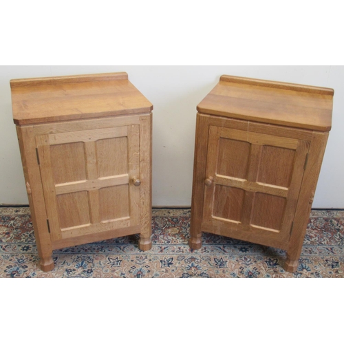 1367 - Robert Mouseman Thompson of Kilburn - a pair of panelled oak bedside cabinets sideboard with adzed t... 