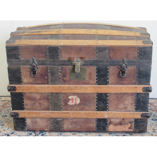 1427 - Victorian metal and wood strap bound leather covered dome top travelling trunk, with fitted interior... 