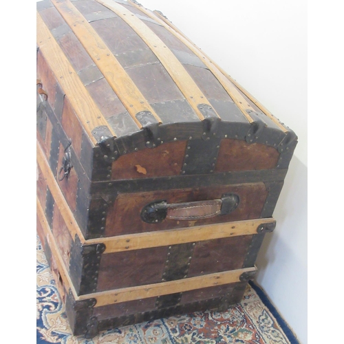 1427 - Victorian metal and wood strap bound leather covered dome top travelling trunk, with fitted interior... 