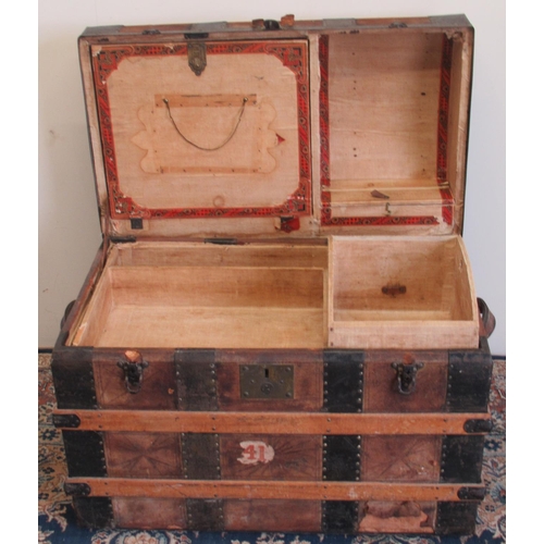 1427 - Victorian metal and wood strap bound leather covered dome top travelling trunk, with fitted interior... 