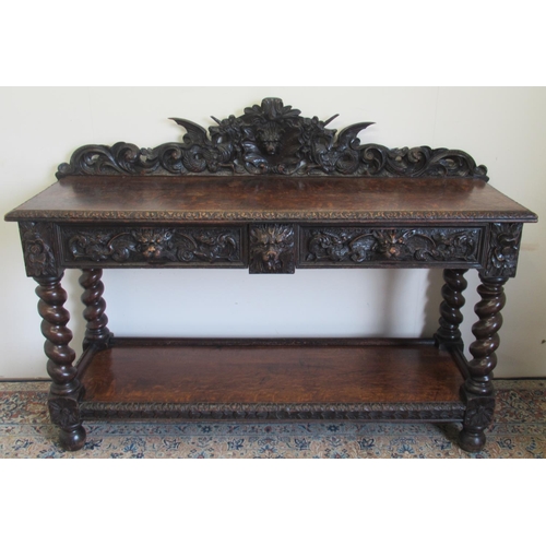 1422 - Victorian oak side table, the raised pierced back carved with mask heads and scrolls, the two frieze... 