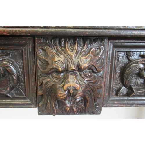 1422 - Victorian oak side table, the raised pierced back carved with mask heads and scrolls, the two frieze... 