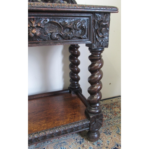 1422 - Victorian oak side table, the raised pierced back carved with mask heads and scrolls, the two frieze... 