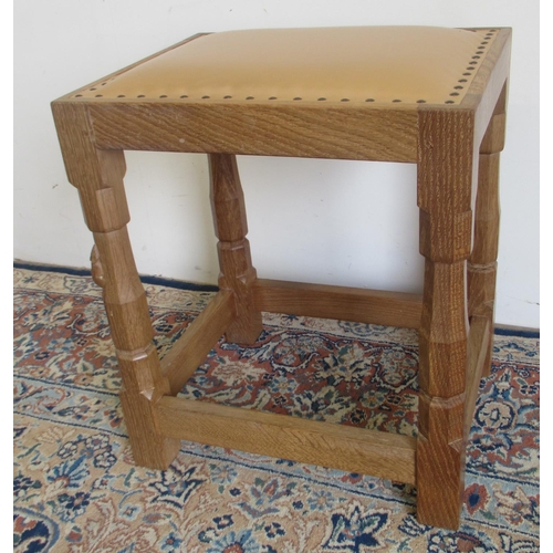 1384 - Robert Mouseman Thompson of Kilburn - an oak dressing table stool, nailed cowhide upholstered top, o... 