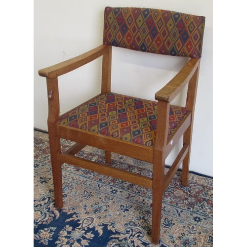 Robert Mouseman Thompson of Kilburn - an oak open arm chair, with nailed upholstered back and seat on square tapered supports, carved with signature mouse, W57cm D51cm H91cm