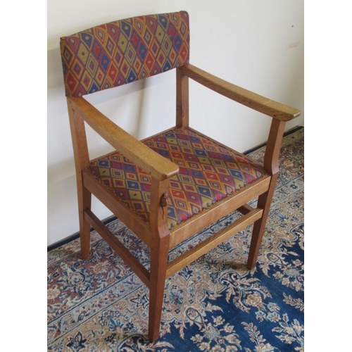 1377 - Robert Mouseman Thompson of Kilburn - an oak open arm chair, with nailed upholstered back and seat o... 