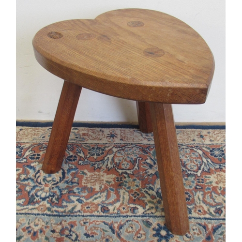 1398 - Alan Acornman Grainger, Acorn Industries Brandsby - an oak low stool, heart shaped seat on three fac... 