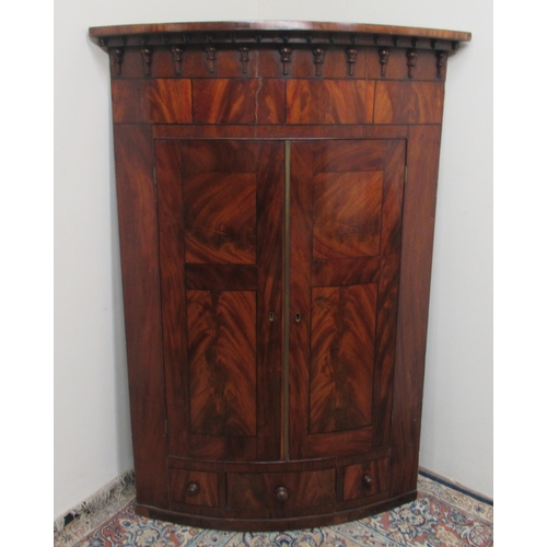 1425 - William IV figured mahogany bow front corner cupboard, shaped cornice with acorn moulded frieze abov... 