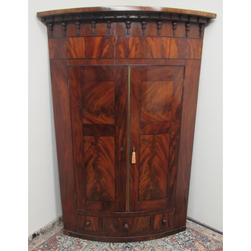 1425 - William IV figured mahogany bow front corner cupboard, shaped cornice with acorn moulded frieze abov... 