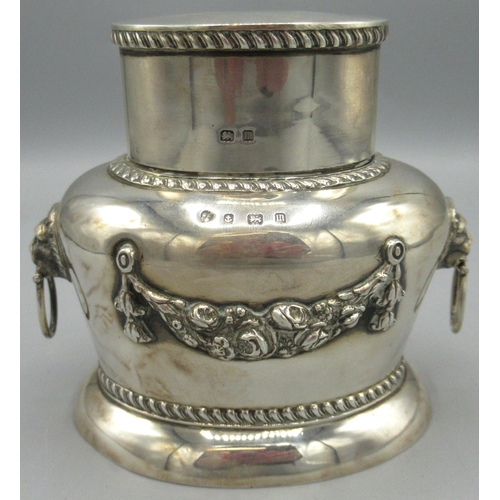 1068 - George V silver tea caddy and cover, ovoid body with floral swag, gadrooned borders and lion mask an... 