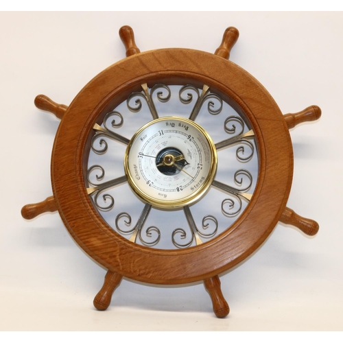 1401 - Acorn Industries of Brandsby - an oak and wrought metal aneroid barometer in the form of an eight sp... 