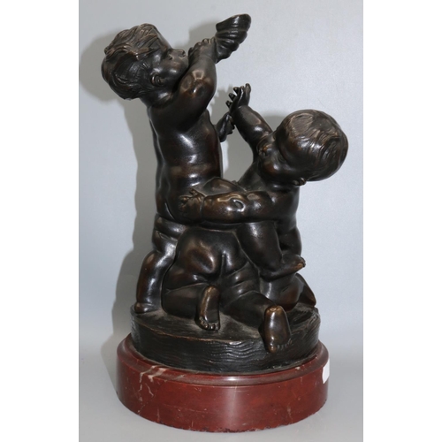 1091 - 19th century bronze group modelled as three putti, raised on circular red marble base, H29.5cm