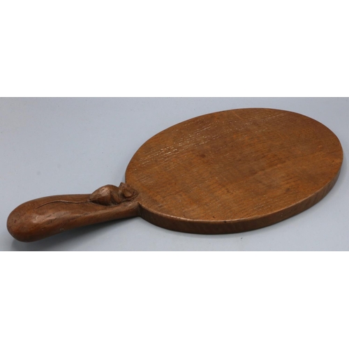 1392 - Robert Mouseman Thompson of Kilburn - an oak oval cheese board, the handle carved with signature mou... 