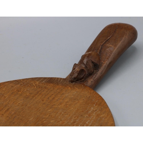 1392 - Robert Mouseman Thompson of Kilburn - an oak oval cheese board, the handle carved with signature mou... 