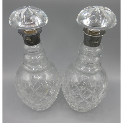 1048 - Pair of Georgian cut glass decanters with silver mounts and mushroom stoppers, hallmarks rubbed, one... 