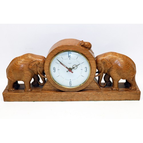 1361 - Robert Mouseman Thompson of Kilburn - oak mantel clock, with circular dial and two elephants on a pl...