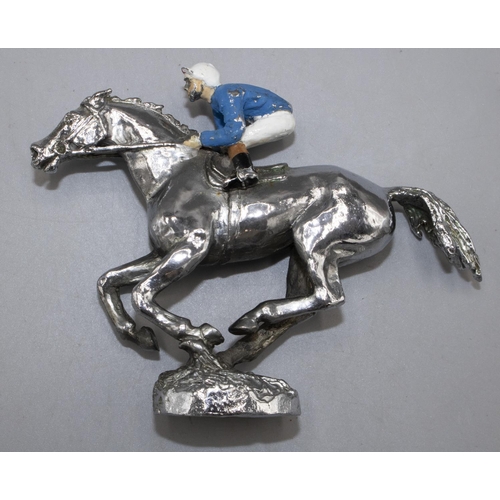 1131 - Chromed metal car bonnet mascot, modelled as a galloping racehorse with jockey in enamelled silks up... 