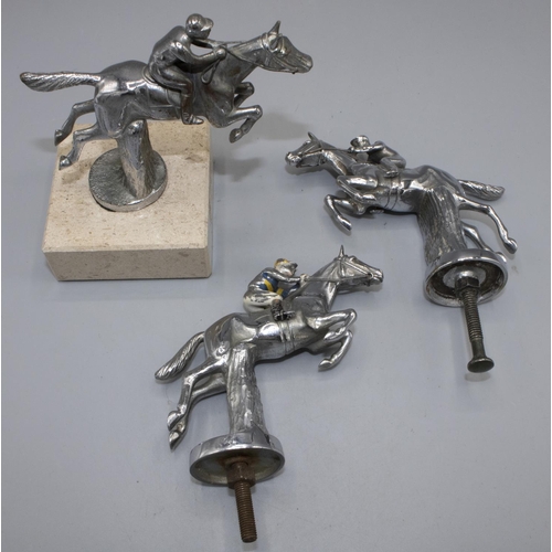 1126 - Chromed metal car bonnet mascot, modelled as a racehorse taking a fence with jockey in enamelled sil... 