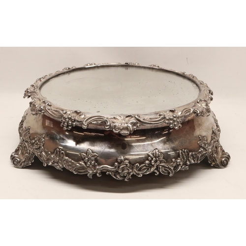 1049 - Large EPNS mirror top cake stand, relief decorated with grapes, scrolls and leafage on four scroll f... 