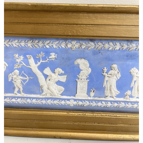 1097 - Wedgwood blue Jasper dip type fire surround tablet, decorated with figures by a brazier in a repeati... 