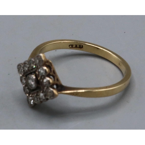 1003 - 18ct yellow gold ring set with diamonds, the central stone surrounded  by a diamond border, on plain... 