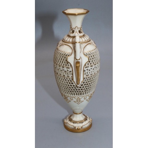 1185 - George Owen for Royal Worcester, a reticulated twin handled pedestal vase, 1911 date mark, ovoid for... 