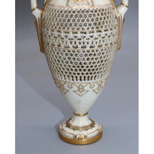 1185 - George Owen for Royal Worcester, a reticulated twin handled pedestal vase, 1911 date mark, ovoid for... 