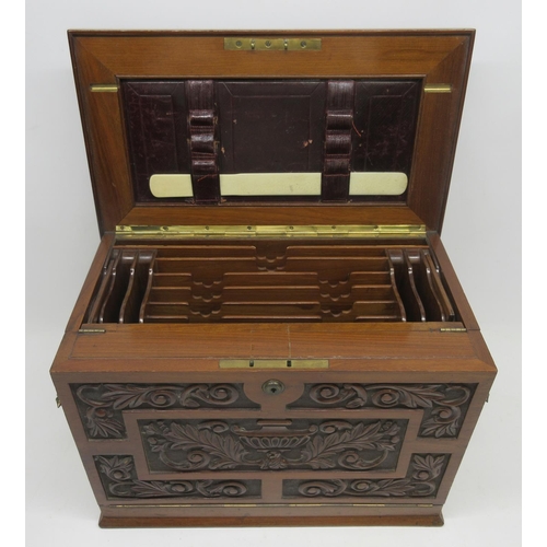 1089 - Victorian walnut tabletop stationery cabinet carved with urn and stylised foliage, opening to reveal... 