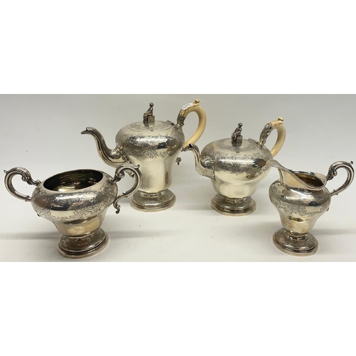 1029 - William IV silver four piece pear shaped coffee and tea service, chased Chinoiserie decoration, the ... 