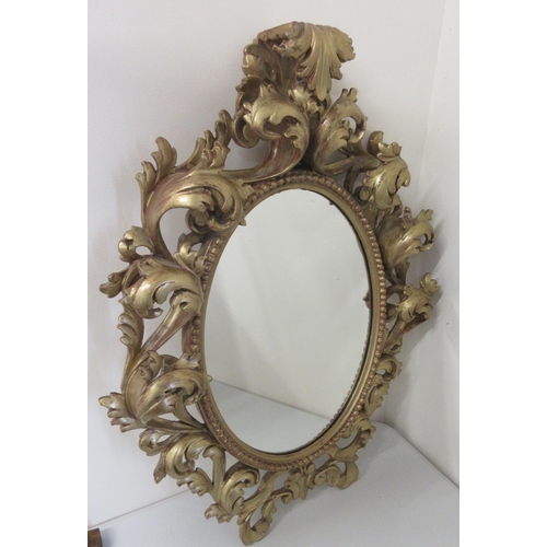 1452 - Florentine style gilt wall mirror, oval plate with beaded and acanthus scroll frame, H70cm