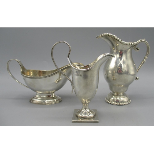 103 - Edwardian silver milk jug on a square foot, with sweeping handle by Henry Williamson Ltd, Birmingham... 