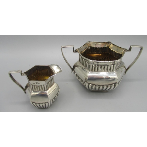 105 - Victorian silver sugar bowl in hexagonal form, twin handled, part lobed body, 1898, and a matching m... 