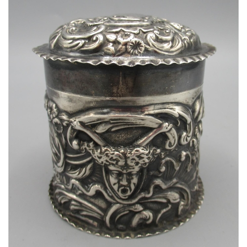 106 - Victorian silver tea caddy decorated in relief with faces, foliate and scrolling repousse by William... 