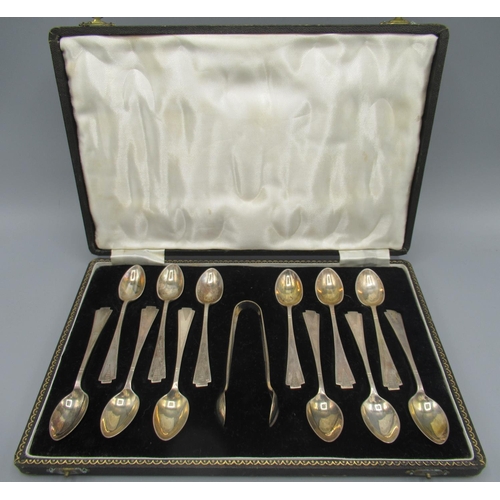 108 - C20th silver cased set of twelve teaspoons with sugar tongs, in an Art Deco style, triangular engine... 