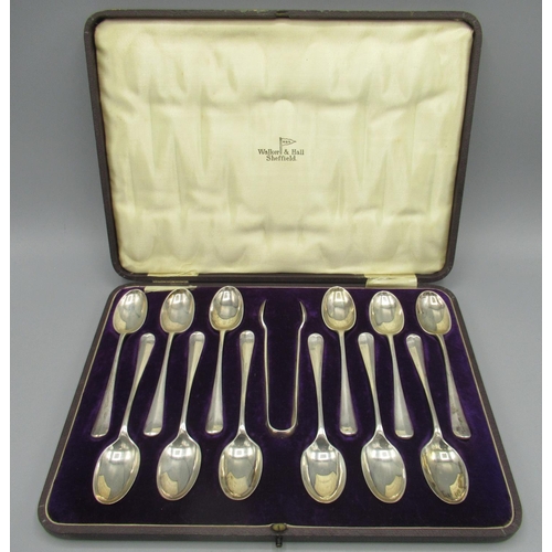 109 - George V silver cased set of twelve monogrammed teaspoons with sugar tongs, hanover finials and rat ... 