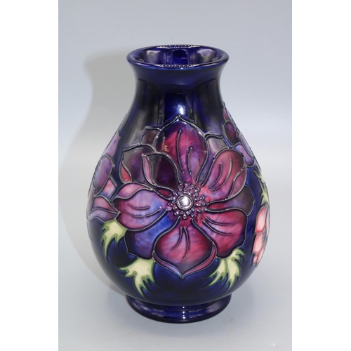 710 - Moorcroft Pottery, Anemone pattern baluster vase, red and purple flowers on dark blue ground, H19cm