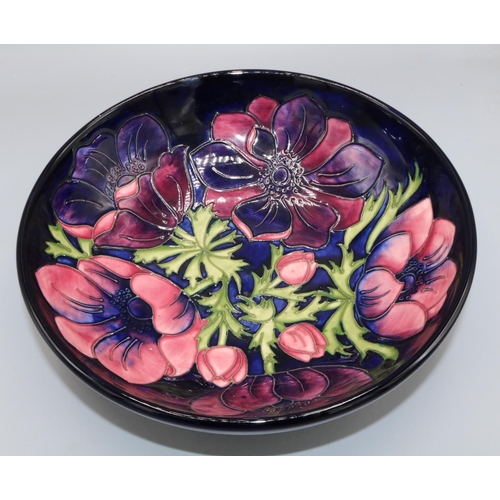 705 - Moorcroft Pottery, Anemone pattern fruit bowl, red and purple flowers on dark blue ground, D26.5cm