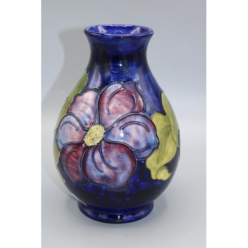 706 - Moorcroft Pottery, Anemone pattern vase, purple and red flowers on blue wash ground, H19cm