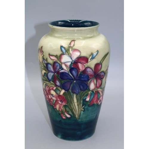 717 - Moorcroft Pottery, Spring Flowers and Orchids pattern high shouldered vase, purple flowers on gradua... 