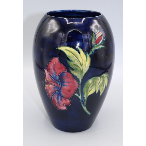 721 - Moorcroft Pottery, Hibiscus pattern ovoid vase, red and yellow flowers on dark blue ground, H18.5cm