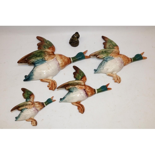 262 - Four Beswick wall mounted flying ducks, models 596-1/2/3/4, max. H25cm, and a glass bird paperweight... 