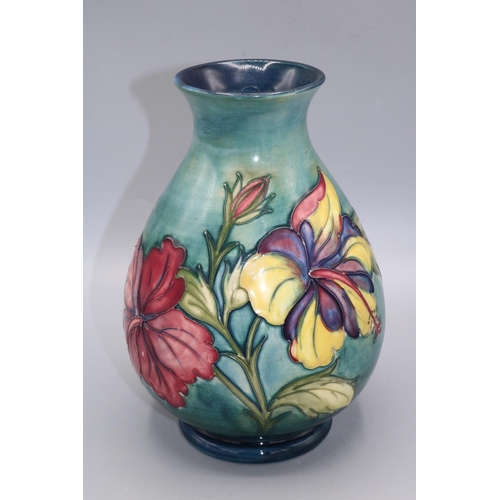 712 - Moorcroft Pottery, Hibiscus pattern baluster vase, graduated green ground, H22cm, restoration and cr... 