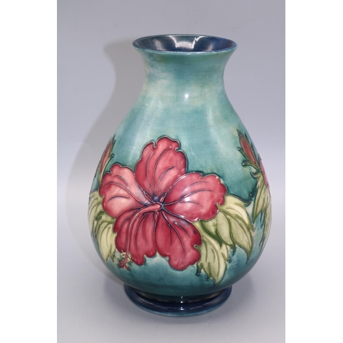 712 - Moorcroft Pottery, Hibiscus pattern baluster vase, graduated green ground, H22cm, restoration and cr... 