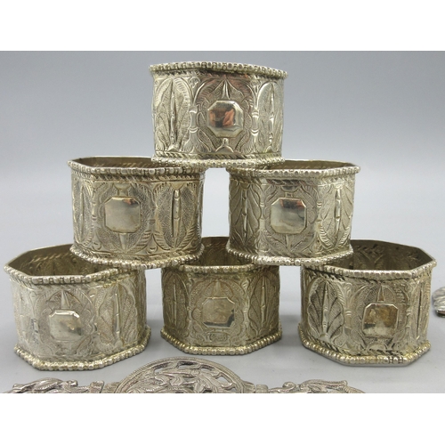 129 - Unmarked white metal belt buckle, unmarked white metal set of six napkin rings (both possibly Indian... 