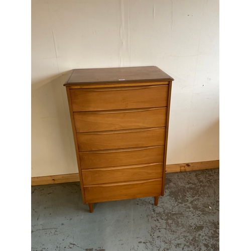 676 - Mid-century teak chest of six long drawers, on turned feet, W68cm, D47cm, and H112cm