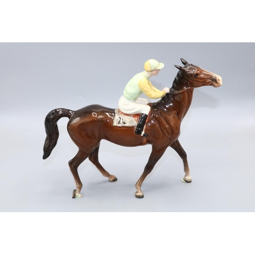 307 - Beswick jockey on walking horse, model 1037, jockey in yellow and green colours, H21.5cm