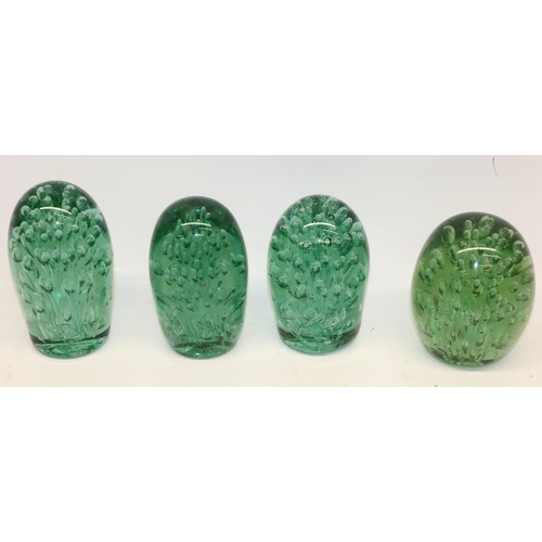 314 - Four Victorian green glass dumps, all with sprays of air bubbles, max. H12.5cm