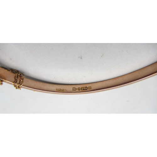 12 - Late Victorian 9ct rose gold hinged bangle with horseshoe design set with seed pearls, 5.63g